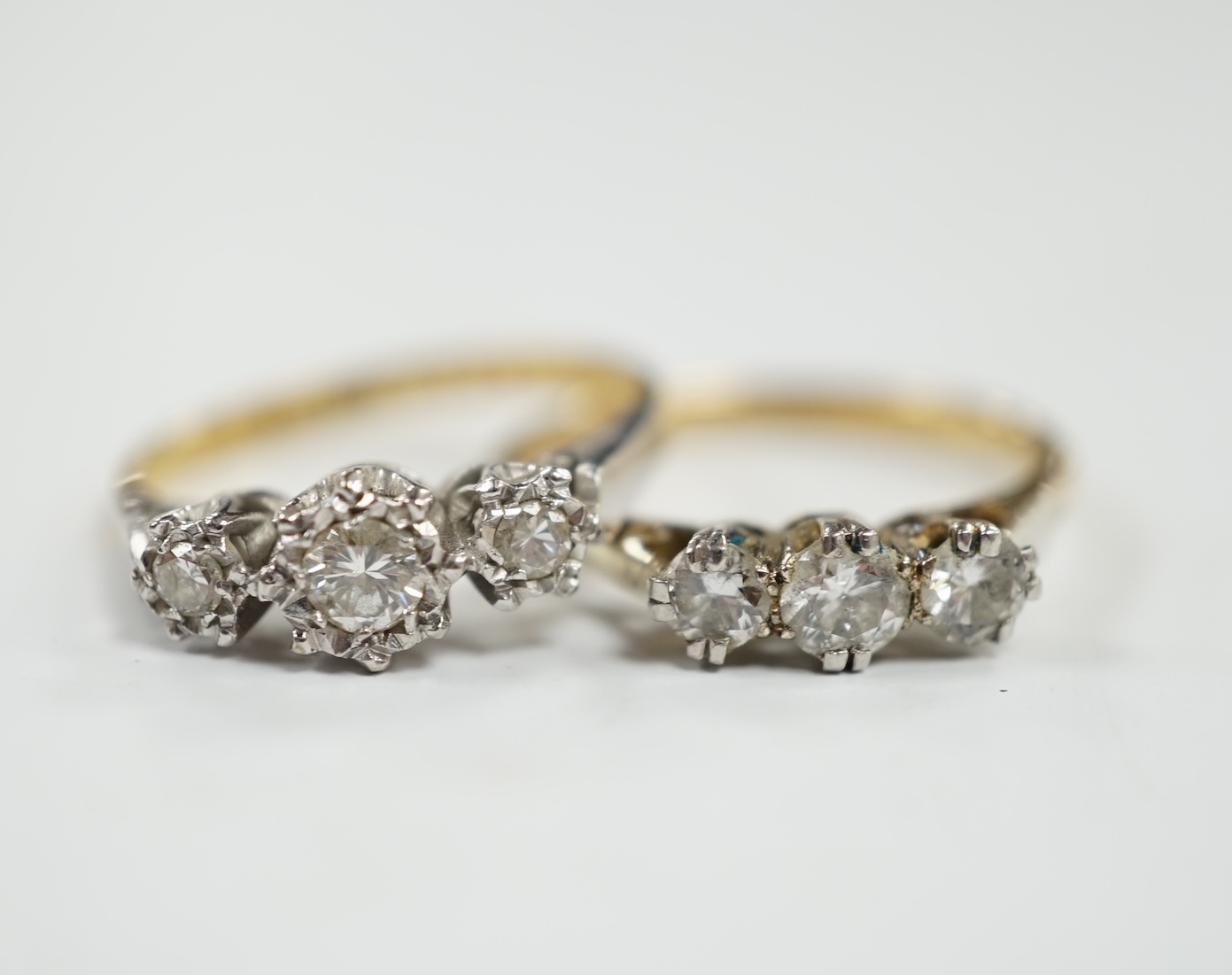 Two 18ct, plate and illusion set three stone diamond rings, sizes O & P, gross weight 6.3 grams. Condition - fair to good